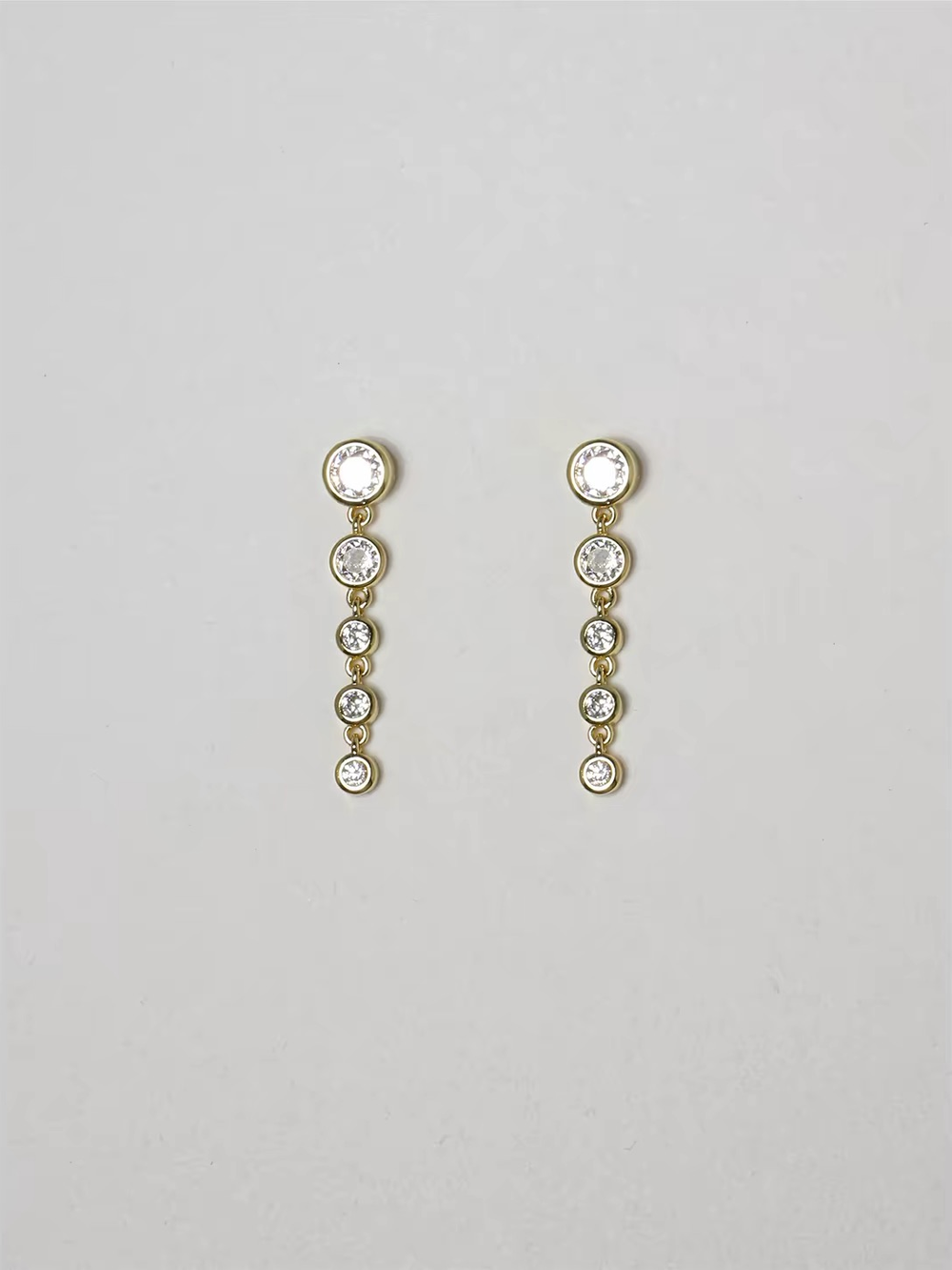 Cascade Earrings in gold with graduated round zirconia drops