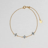 Clover Bracelet in gold with three pale blue four-petal floral stones