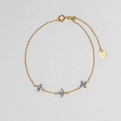 Clover Bracelet in gold with three pale blue four-petal floral stones