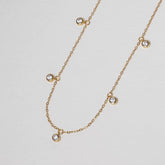 Pluie de Lumière Necklace in gold with five bezel-set zirconia drops