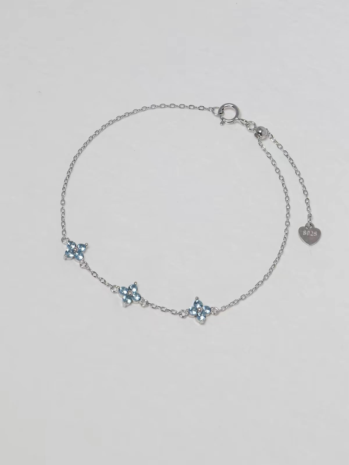 Clover Bracelet in silver with three pale blue four-petal floral stones