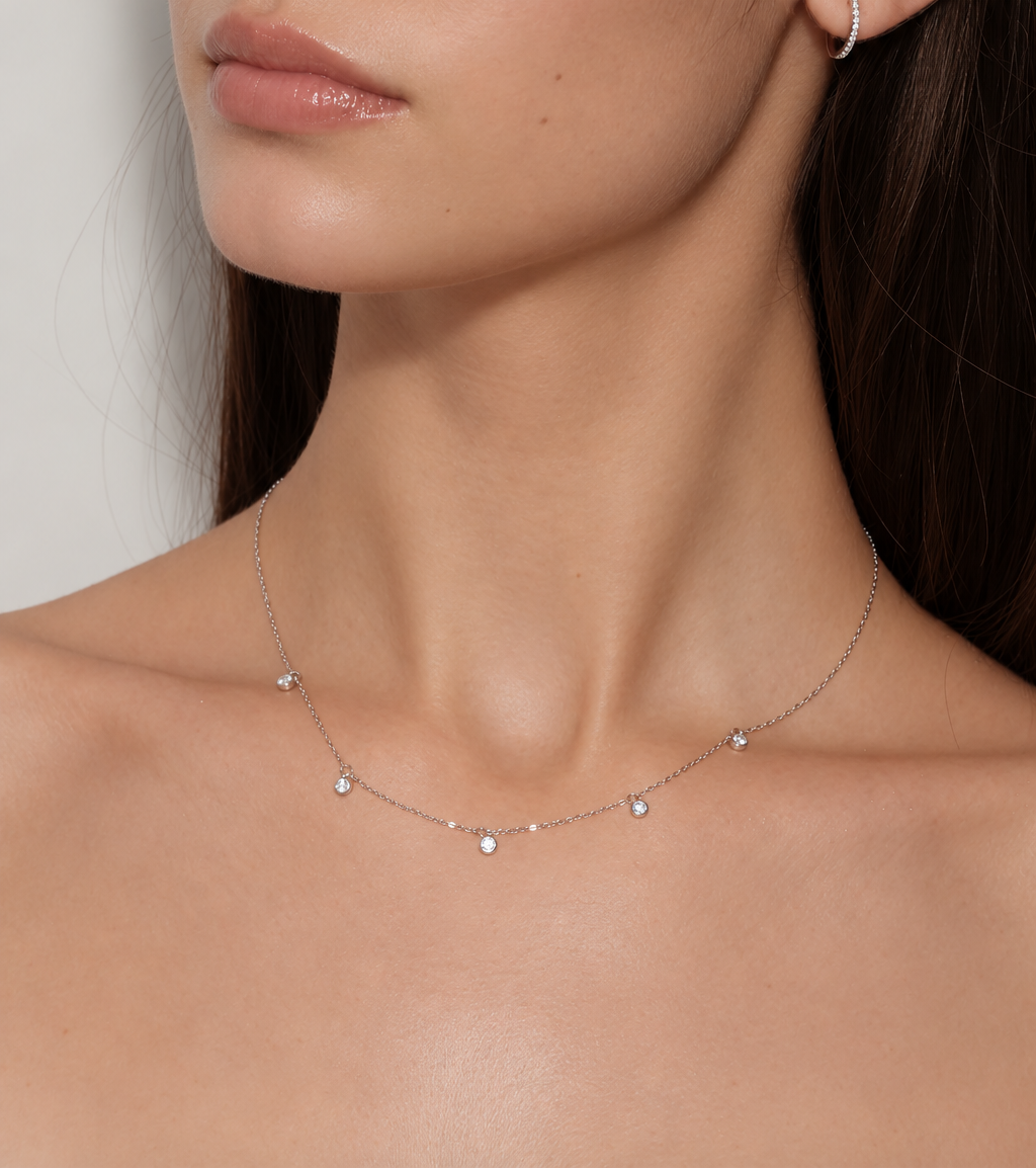 Model wearing Pluie de Lumière Necklace in silver, angled close-up